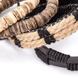 Macro shot of multi-layer leather bracelets with wooden beads and woven texture