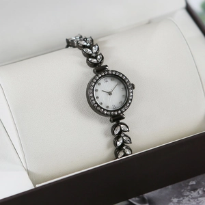 Detail of luxury mermaid bracelet watch with rhinestone leaf links in a gift box