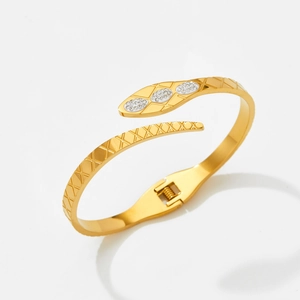 Detailed view of the gold snake head bangle with micro-pave crystals and spring closure