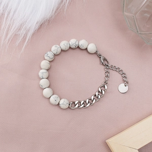 Detail of beaded steel chain bracelet with white turquoise stones and lobster clasp closure