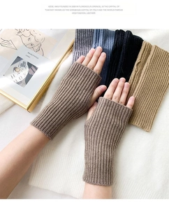 Detail of ribbed knit fingerless gloves in dark brown covering the wrist and forearm