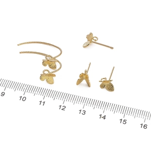 14K gold plated leaf earrings set with ruler for size measurement on white background