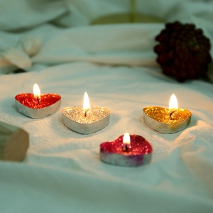 Glitter heart-shaped tea light candles in red, gold, and silver for romantic decoration