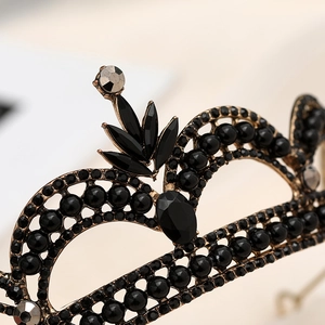 Detailed macro view of black crystal gems and pearls on vintage baroque crown