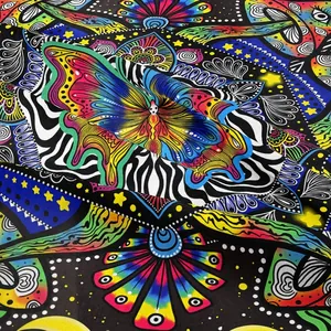 Bohemian psychedelic tapestry featuring colorful butterfly and mushroom prints