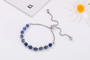 Macro view of blue stone beads and adjustable silver slider chain on the bracelet