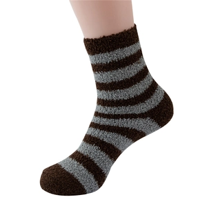 Close-up of brown and gray striped coral fleece socks with a soft plush texture