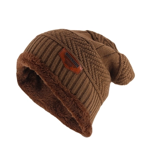 Detail of warm coffee brown knitted beanie with thick fleece lining and leather patch