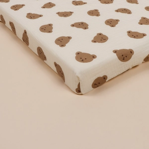 Detail of baby bassinet fitted sheet made of soft double-layer cotton crepe with bear print
