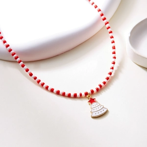 Detailed close-up of handmade beaded Christmas necklace with festive tree pendant
