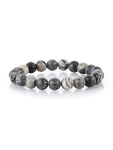 Macro detail of natural stone beaded bracelet with marble texture and polished finish