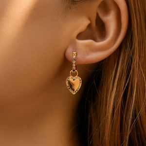 Bohemian gold heart earrings with colorful zircon inlay shown on a female model