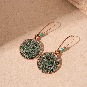 Vintage bohemian bronze drop earrings with turquoise bead accents and floral hollow charms