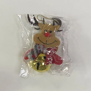 Detail of plush reindeer Christmas tree ornament with golden bell in clear packaging