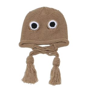 Detail of khaki crochet knit frog hat with large cartoon eyes and braided tassel ties