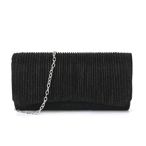 Detail of black pleated clutch bag with shimmering sequins and silver chain strap