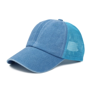 Detail of blue washed denim and breathable mesh fabric on the trucker baseball cap