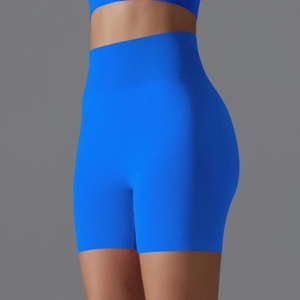 Detail of high-waist seamless yoga shorts in bright blue with ribbed texture