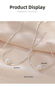 Macro view of 925 silver beaded necklace and bracelet set with central white pearls