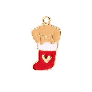 Macro detail of enamel dog in Christmas stocking charm with glitter and golden finish