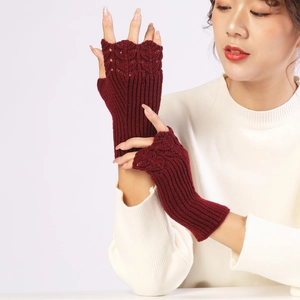 Detailed knit texture of burgundy fingerless gloves with elegant scalloped crochet edges