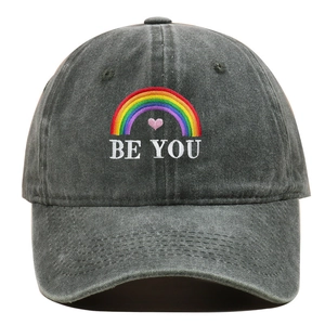 Close-up of rainbow heart embroidery and BE YOU text on washed cotton baseball cap
