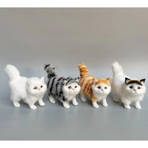 Detail of four realistic plush cats showing textured fur and vivid facial features