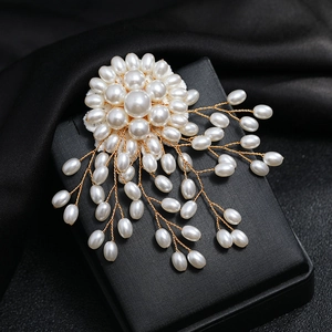 Detailed view of handmade copper wire snowflake brooch with pearls on black texture box