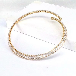 Detail of gold choker necklace with marquise-cut zircons and open-ended design