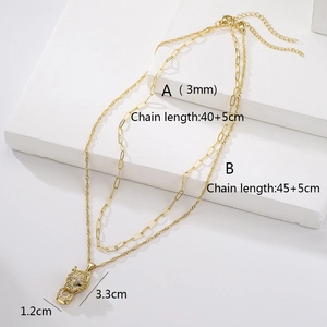 Double-layered gold leopard pendant necklace with zircon pavé on white stone blocks