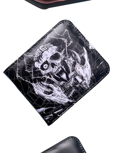 Close-up of a black leather wallet with white retro skull and monster printed design