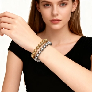Classic gold and silver stainless steel beaded bracelet set worn on model's wrist