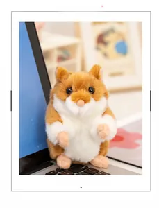 Close-up of golden plush hamster doll with soft fur detail on a laptop keyboard