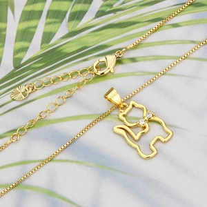 Detailed view of 18k gold plated cat pendant with zircon accents on a box chain necklace