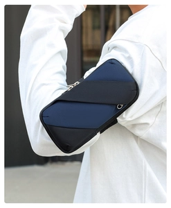 Close-up of a navy and black sports armband featuring dual zippers and durable oxford fabric
