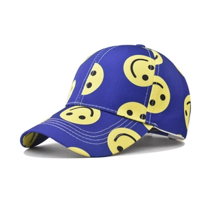 Detailed view of navy cotton baseball cap with all-over yellow smiley face embroidery