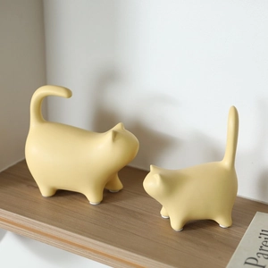 Minimalist ceramic cat figurines with a matte cream finish for modern home shelf decoration