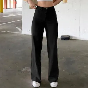 Women's high waist black wide leg denim jeans with a slim fit and minimalist street style