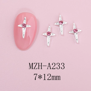 Close-up of 7x12mm silver cross star nail charms with pink rhinestones on a matte base