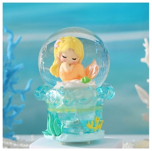 Luminous mermaid crystal ball ornament with blue ocean coral decor on a white pedestal
