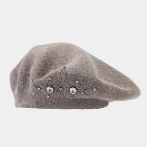 Detailed close-up of rabbit fur beret with elegant rhinestone flower embroidery