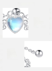 Macro shot of heart-shaped moonstone and 925 sterling silver chain ring details