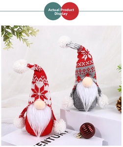 Close-up of plush Christmas gnomes with knitted snowflake hats and fluffy white beards