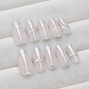 White almond press-on nails with 3D silver cross and rhinestone accents for elegant look