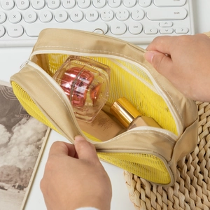 Detail showing the large capacity mesh makeup bag with smooth zipper closure for storage