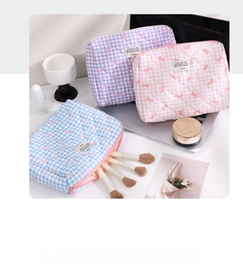 Detailed view of quilted plaid makeup bags with cute bows and premium fabric textures