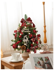 Close-up of 60cm mini Christmas tree with red bows, pine cones and warm LED lights