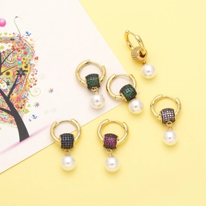 Detailed view of colorful zircon beads and white pearl pendants on golden hoops