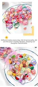 Detailed view of colorful macaron kids hair ties with cartoon flower and fruit charms