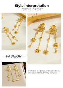 Detail of gold-plated drop earrings with white shell flowers and zircon star charms